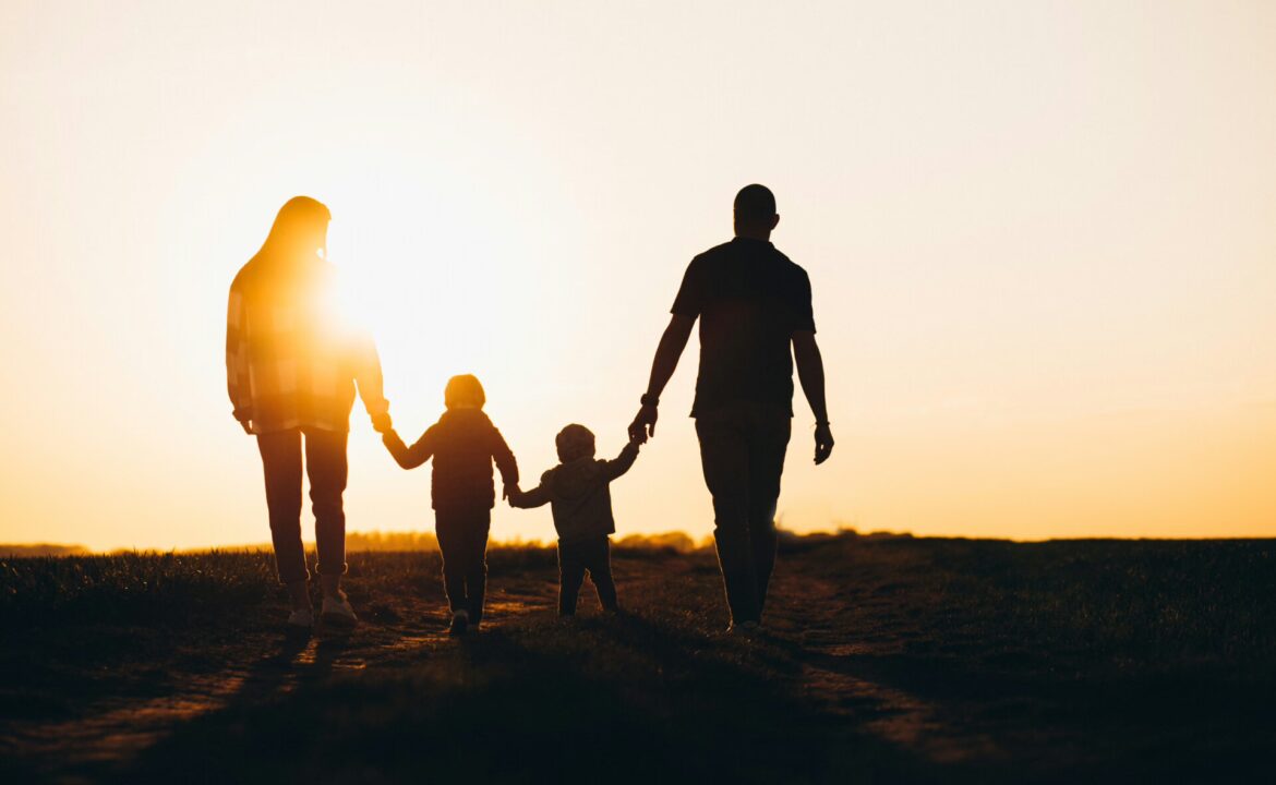 Happy family silhouette on the sunset